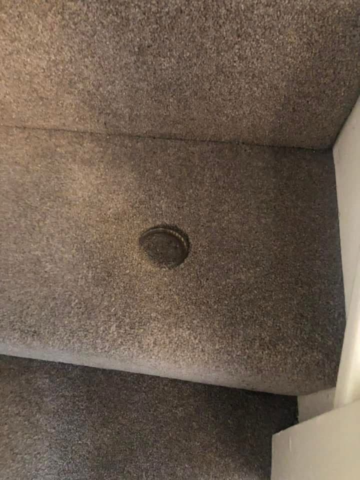 Carpet stair with burn mark before treatment