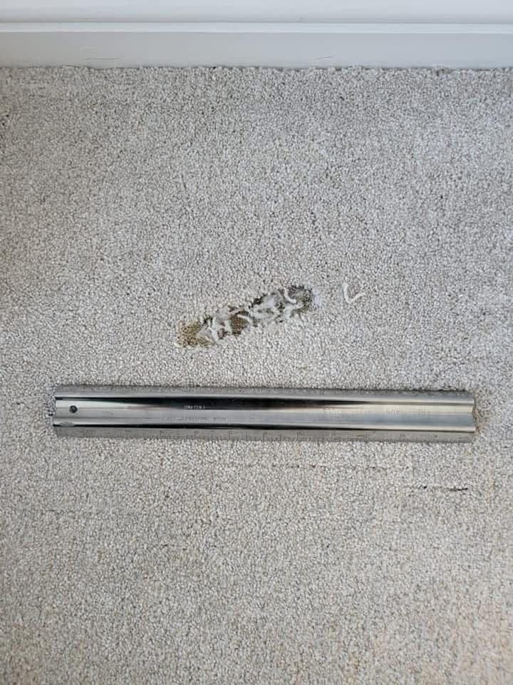Cream carpet with debris stain before treatment