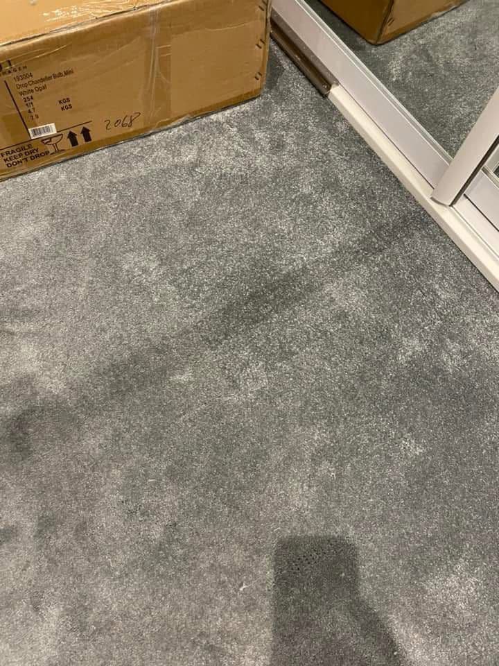 Heavily soiled grey carpet before deep clean