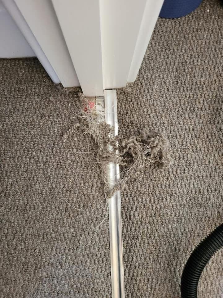 Carpet debris at threshold before cleaning