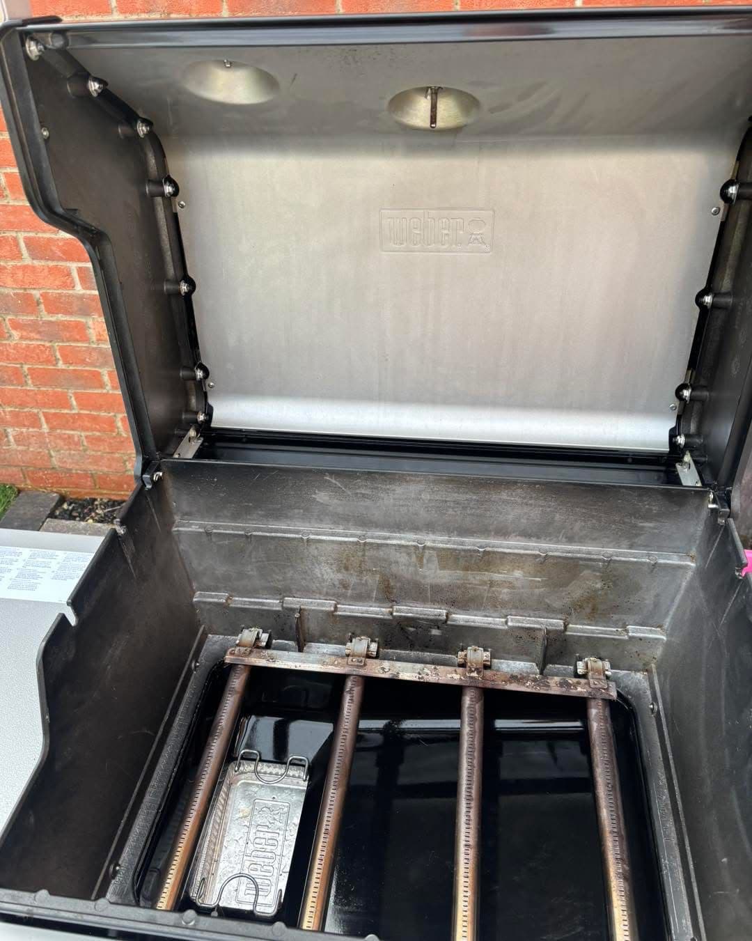 Dirty Weber BBQ interior with grease build-up before cleaning