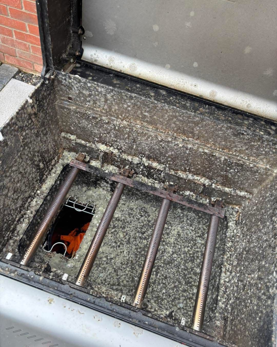 BBQ burners caked in grease and ash before cleaning