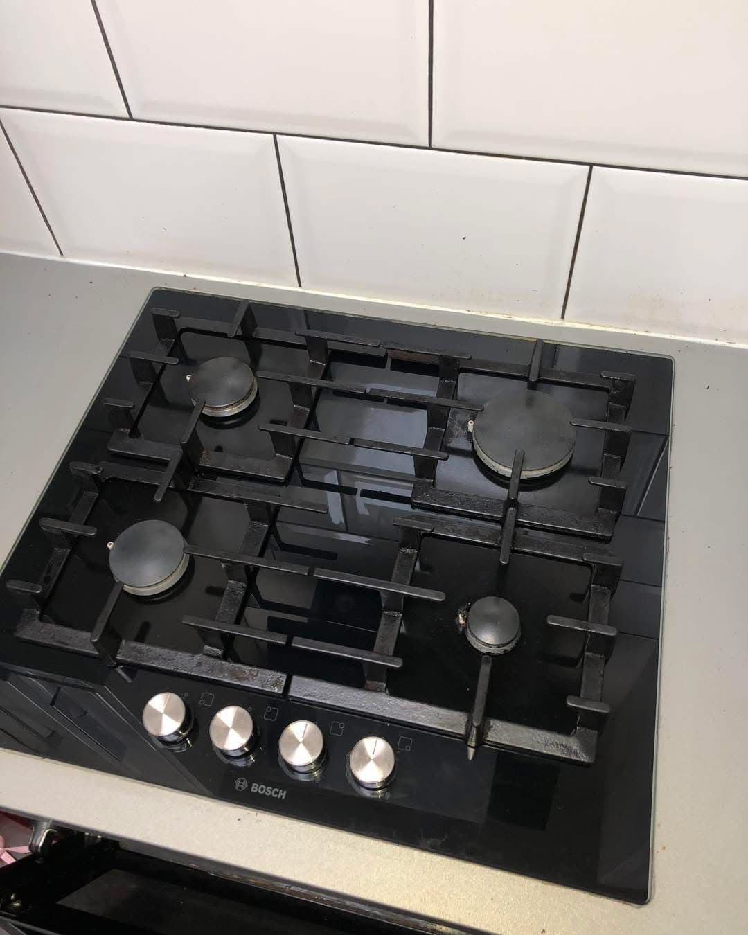 Clean black Bosch 4-burner gas hob after professional cleaning