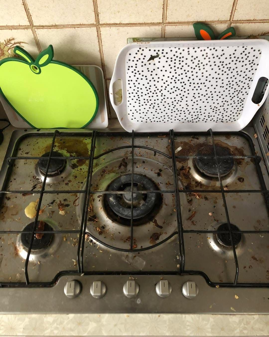 Dirty stainless steel 5-burner gas hob before cleaning