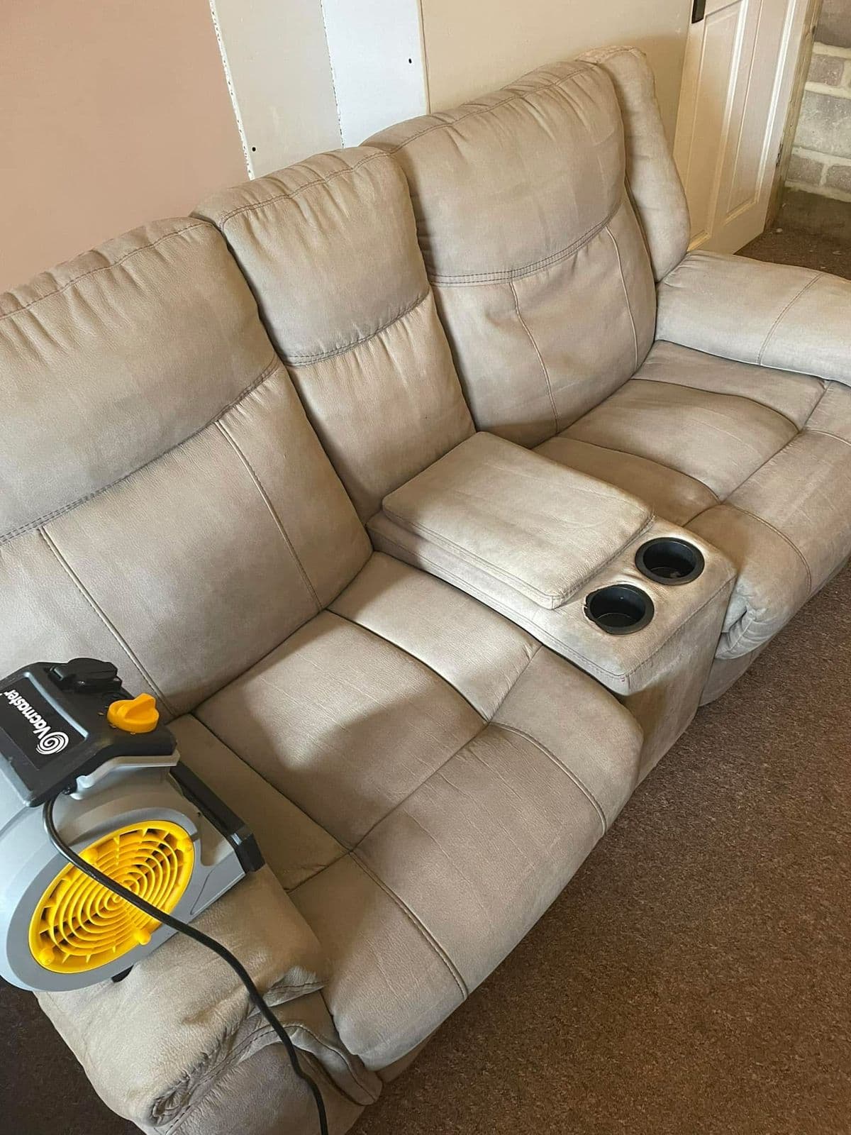 Beige recliner sofa freshly cleaned after professional upholstery treatment