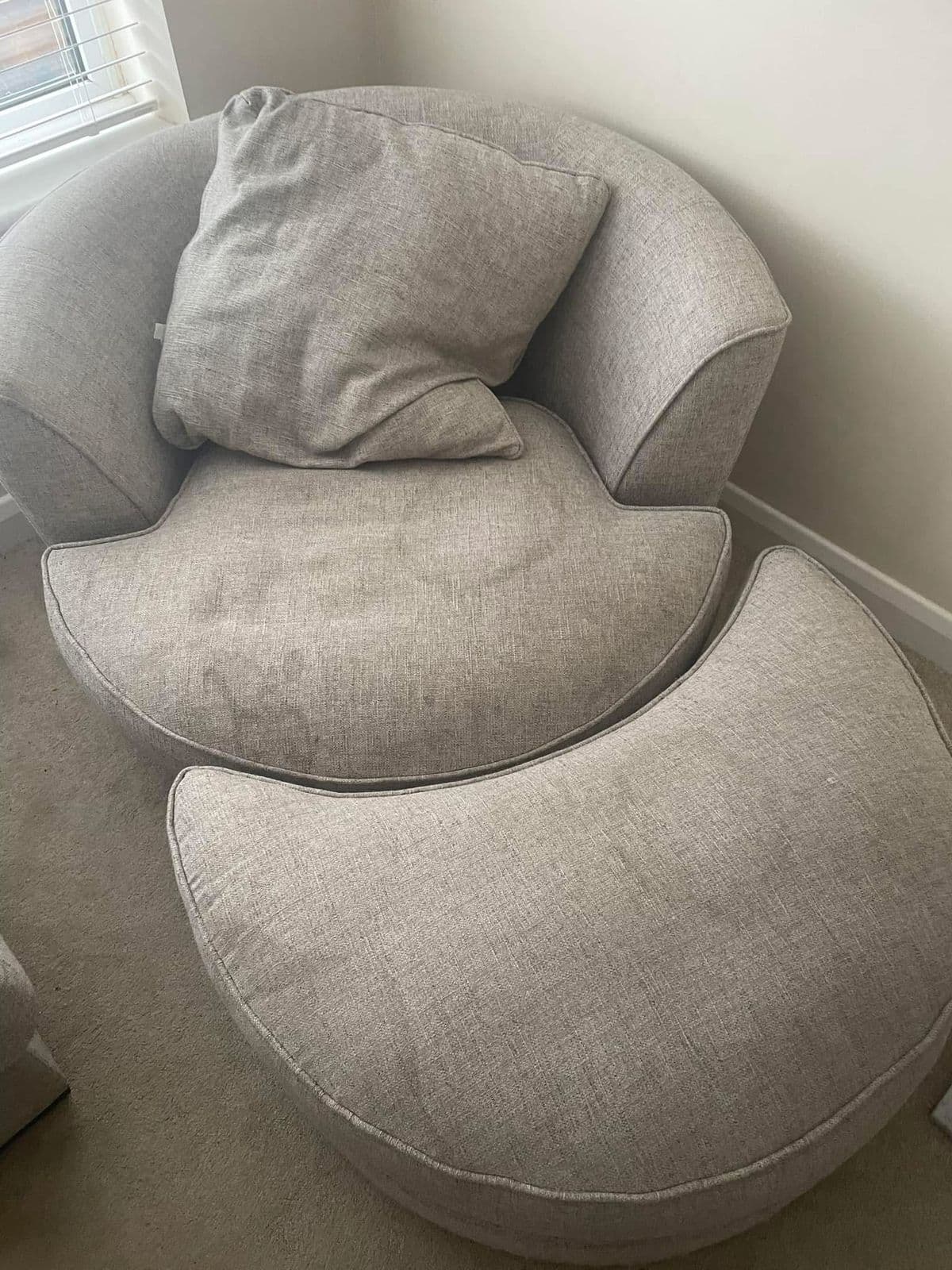 Grey round chair and ottoman with marks before upholstery cleaning