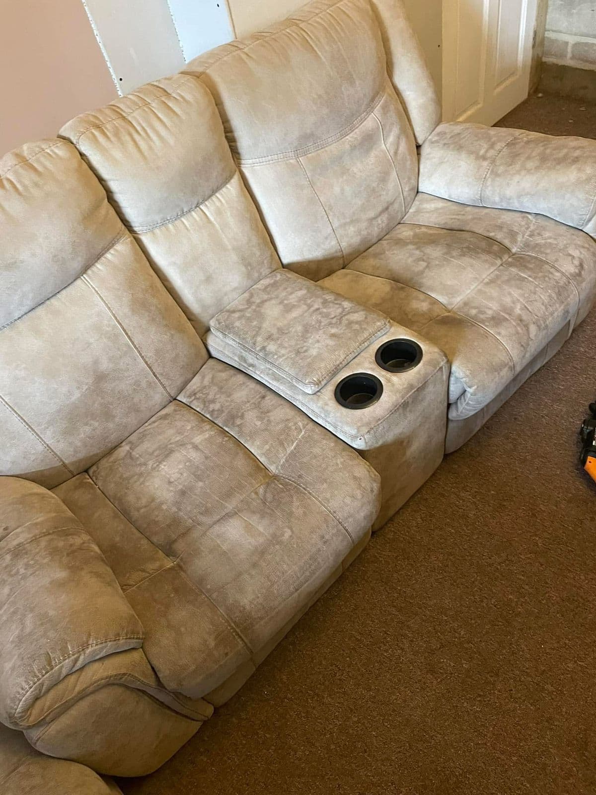 Beige recliner sofa with staining before upholstery cleaning